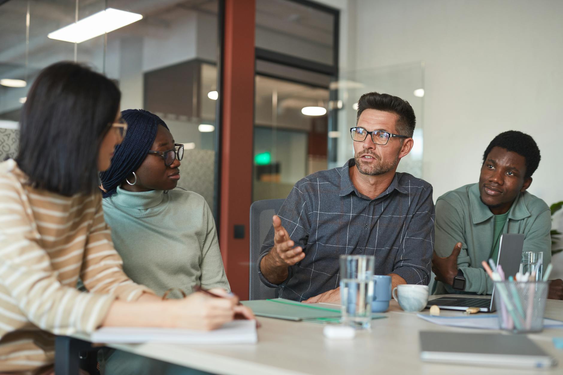 a group of people having a meeting in the office